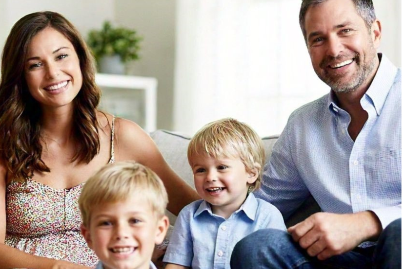 Family in a cozy living room using Life Backup Plan app for home safety, ensuring peace of mind and protection against emergencies or unexpected situations